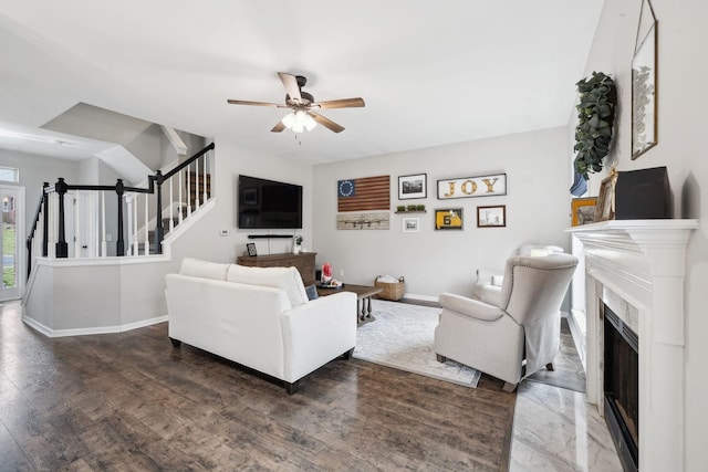 living room with ceiling fan and dark hardwood / wood-style flooring