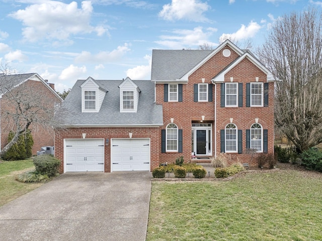 view of front of property featuring a garage and a front lawn