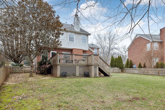 back of property featuring a yard and a deck