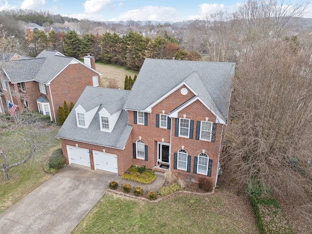 view of front of property with a garage and a front lawn