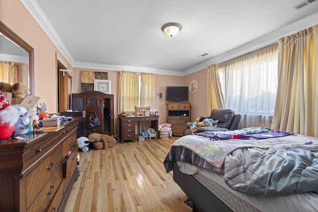 bedroom featuring ornamental molding and light wood-type flooring