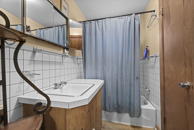 bathroom with tasteful backsplash, shower / tub combo with curtain, vanity, and tile walls