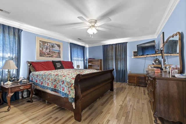 bedroom with crown molding, ceiling fan, and light hardwood / wood-style floors