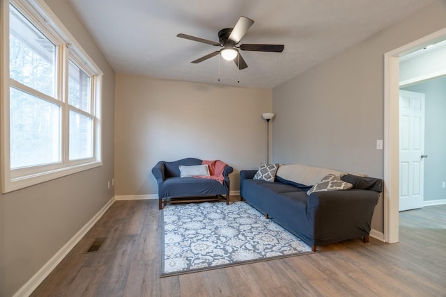 living room featuring hardwood / wood-style flooring and ceiling fan