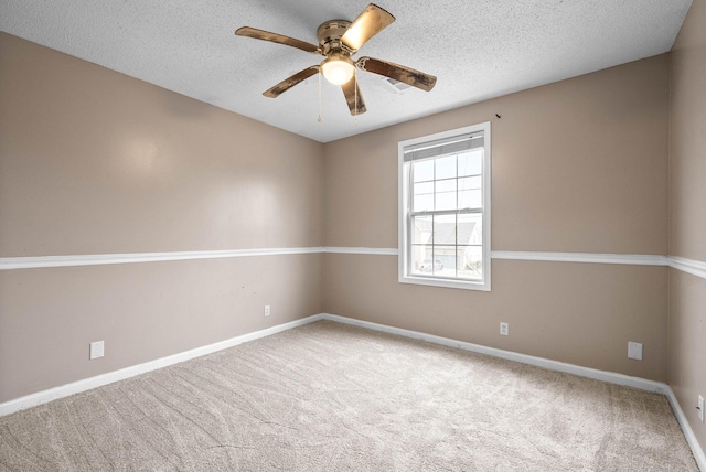 carpeted spare room featuring a textured ceiling and ceiling fan