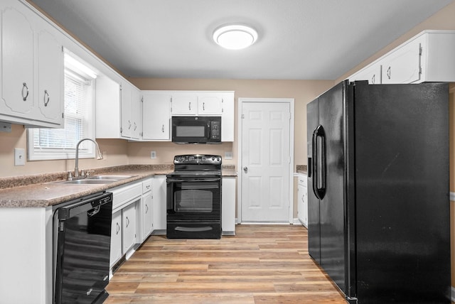 kitchen with white cabinetry, light wood-type flooring, sink, and black appliances