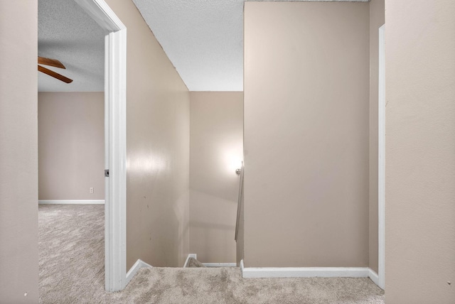 interior space with ceiling fan and a textured ceiling