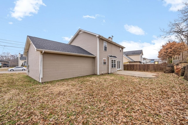 rear view of property featuring a patio area and a lawn