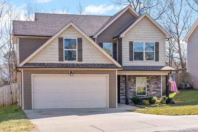 craftsman-style home with a garage, a front yard, and central air condition unit