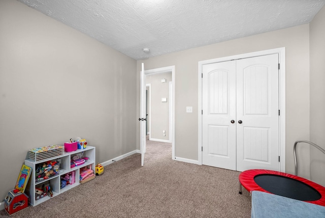 game room featuring carpet and a textured ceiling