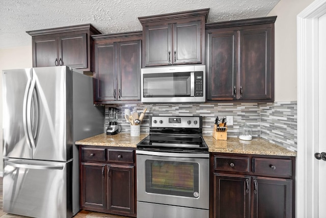 kitchen with tasteful backsplash, light stone countertops, and stainless steel appliances