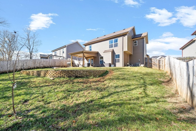 rear view of property with a yard and central AC