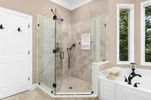 bathroom with ornamental molding and separate shower and tub