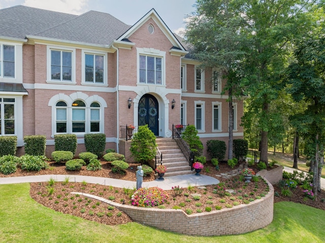 view of front facade featuring french doors and a front yard