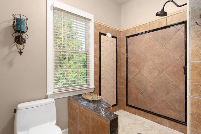 bathroom with tiled shower and toilet