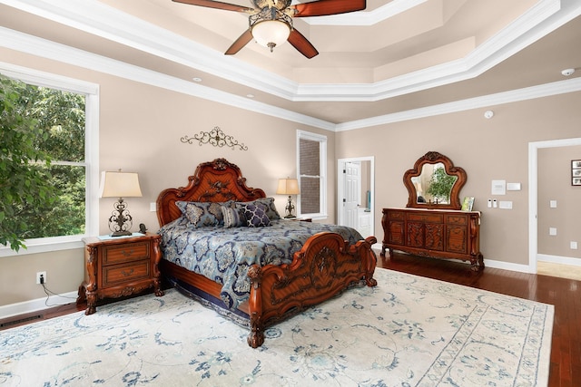 bedroom featuring hardwood / wood-style flooring, ornamental molding, and multiple windows