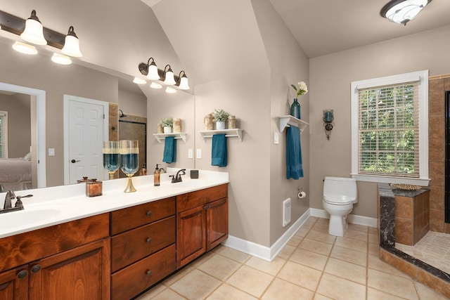 bathroom with a tile shower, lofted ceiling, tile patterned flooring, vanity, and toilet