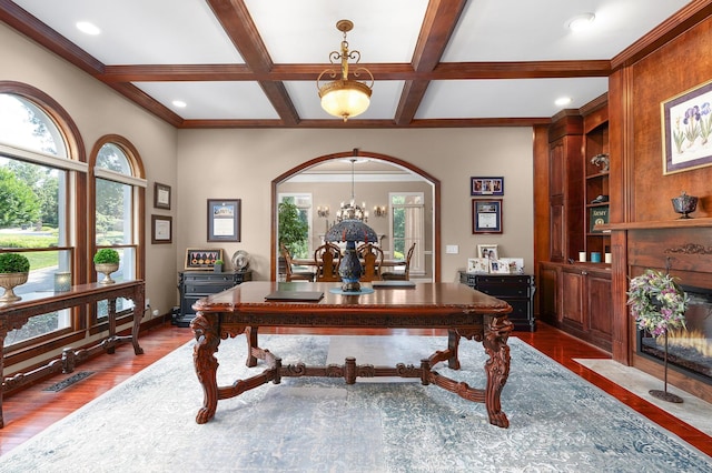 office with a chandelier, coffered ceiling, ornamental molding, dark hardwood / wood-style flooring, and beamed ceiling