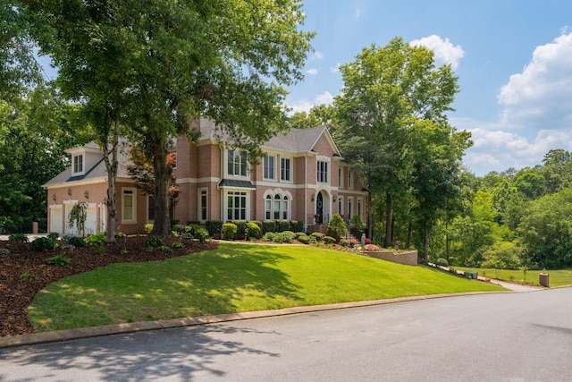 view of front of property with a garage and a front lawn