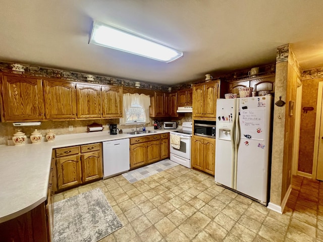 kitchen with sink and white appliances