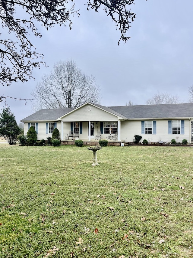 ranch-style home with a porch and a front lawn