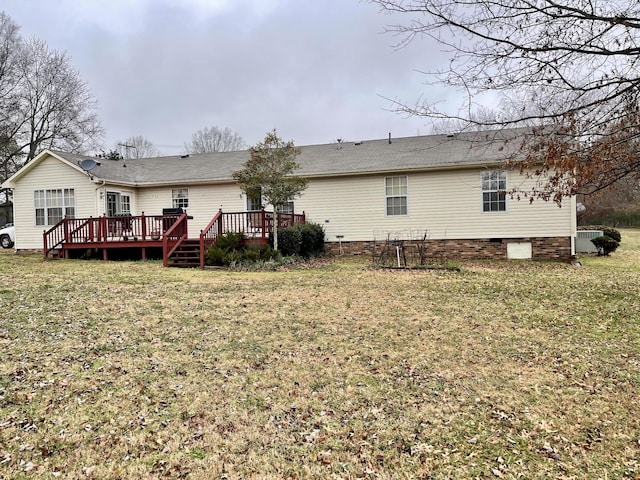 back of house with a wooden deck and a yard