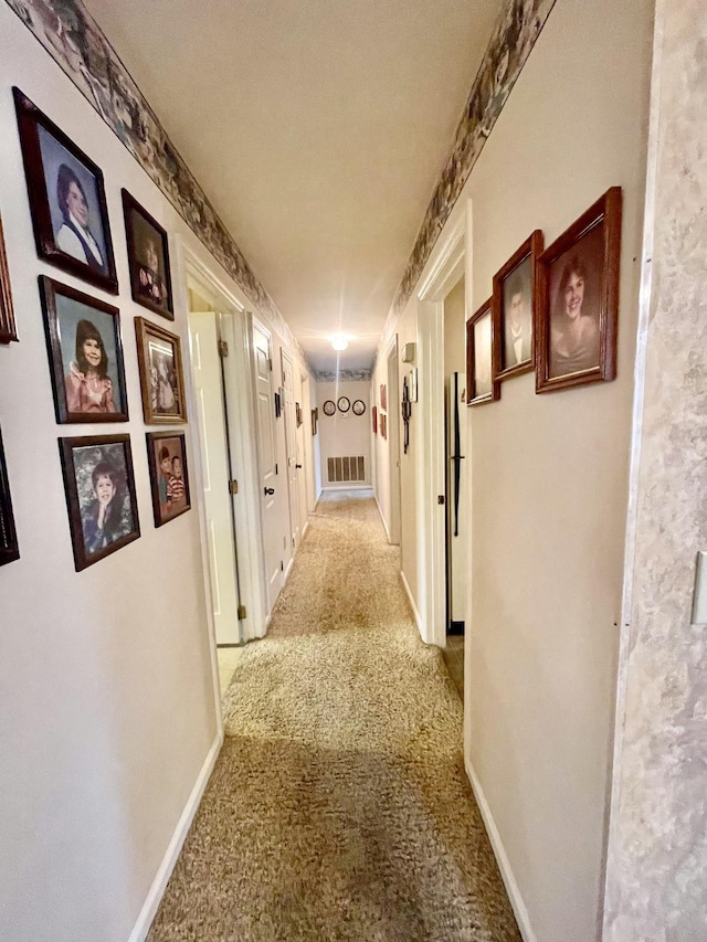 hall featuring light colored carpet