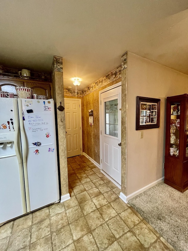 kitchen with white refrigerator with ice dispenser