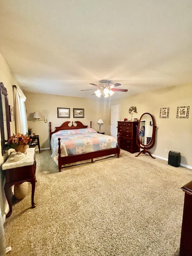 bedroom featuring ceiling fan and carpet