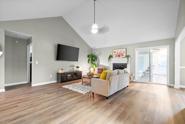 living room with vaulted ceiling, ceiling fan, and light hardwood / wood-style floors