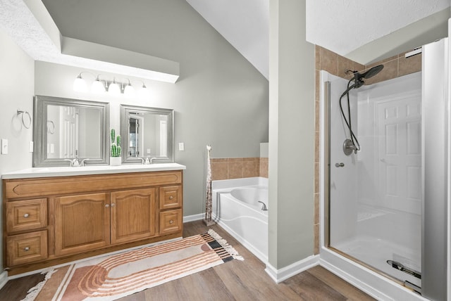 bathroom featuring independent shower and bath, vanity, and hardwood / wood-style floors