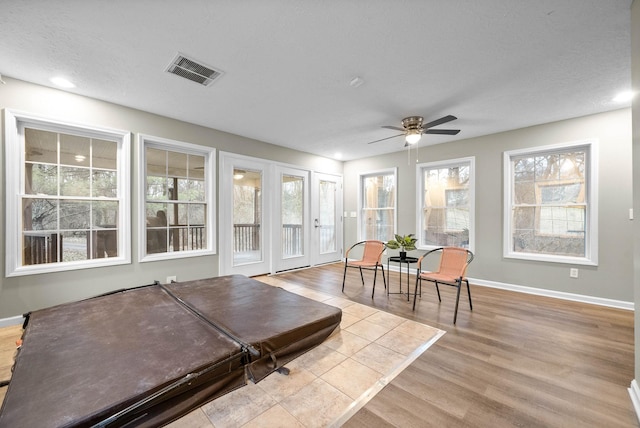 sunroom featuring a wealth of natural light and ceiling fan