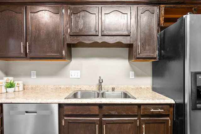 kitchen featuring stainless steel appliances, sink, and dark brown cabinets