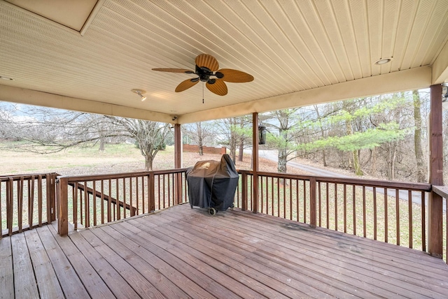 deck featuring ceiling fan and a grill