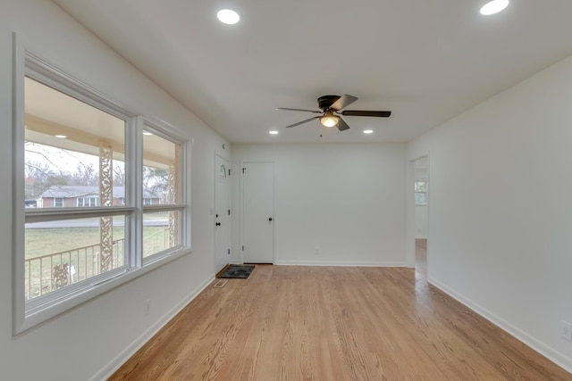 unfurnished room featuring light wood finished floors, baseboards, and recessed lighting