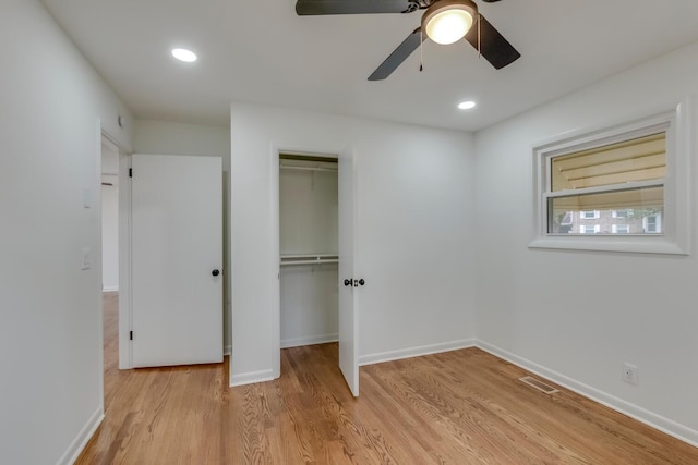 unfurnished bedroom featuring a closet, visible vents, baseboards, and light wood finished floors