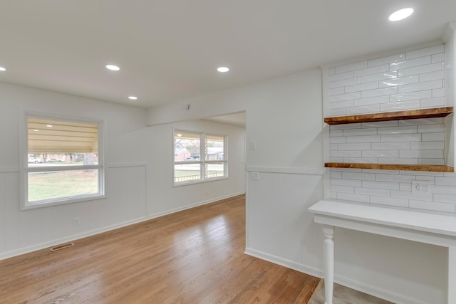 interior space with visible vents, wainscoting, light wood-style flooring, and recessed lighting