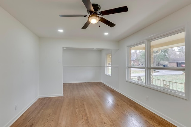 empty room featuring recessed lighting, wood finished floors, a ceiling fan, and baseboards