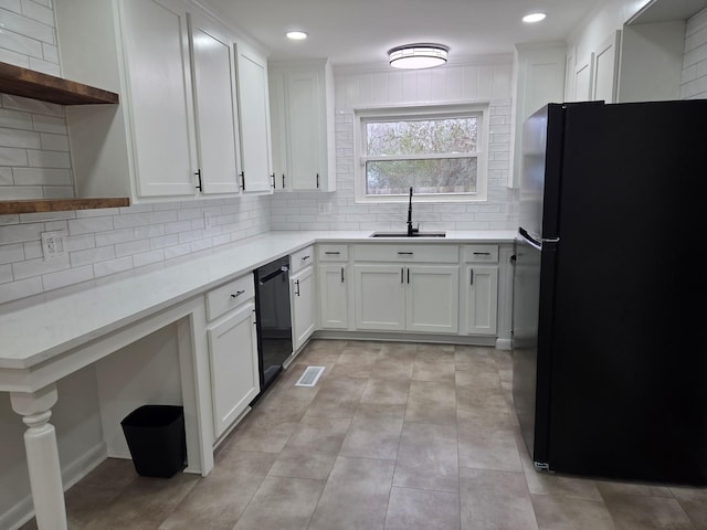 kitchen with tasteful backsplash, black appliances, white cabinetry, open shelves, and a sink