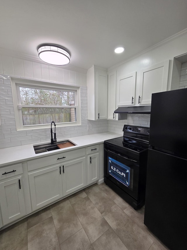 kitchen featuring tasteful backsplash, a sink, under cabinet range hood, and black appliances