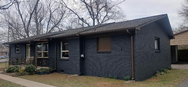 view of side of home featuring brick siding