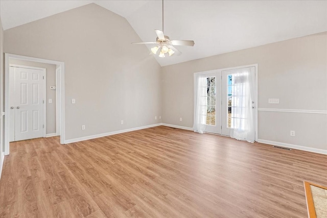 spare room featuring lofted ceiling, light hardwood / wood-style flooring, and ceiling fan