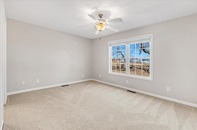 spare room with ceiling fan and carpet floors