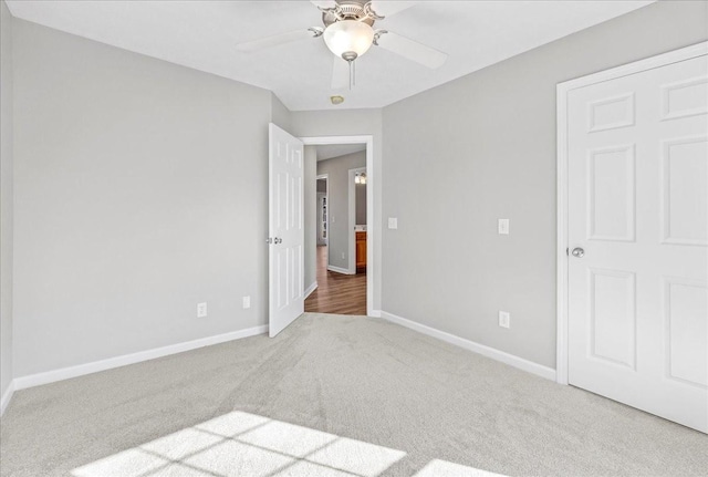 unfurnished bedroom featuring ceiling fan and carpet