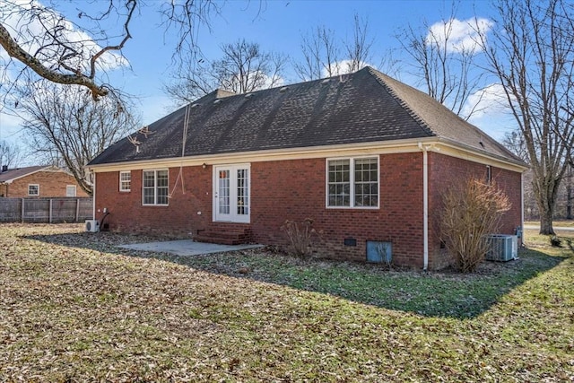 rear view of property with a lawn, central AC, and a patio area