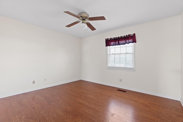 spare room featuring wood-type flooring and ceiling fan