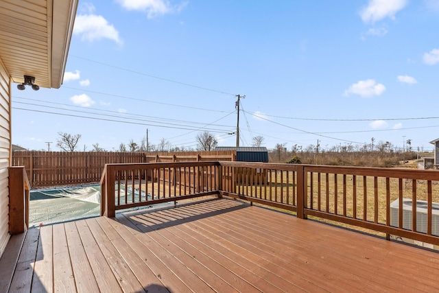 wooden deck featuring cooling unit