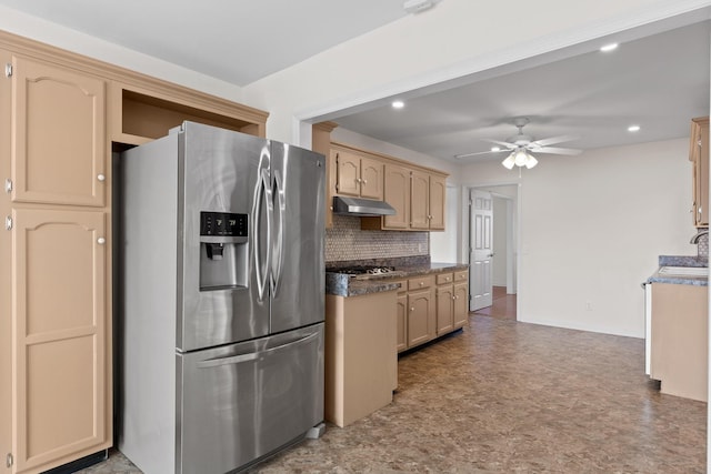 kitchen with appliances with stainless steel finishes, light brown cabinetry, tasteful backsplash, sink, and ceiling fan