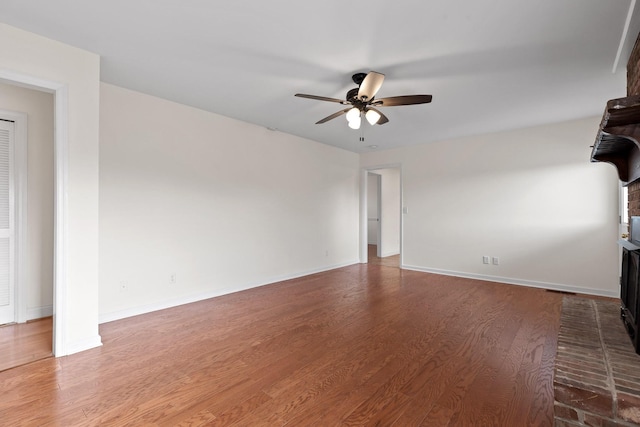 unfurnished living room featuring hardwood / wood-style floors and ceiling fan