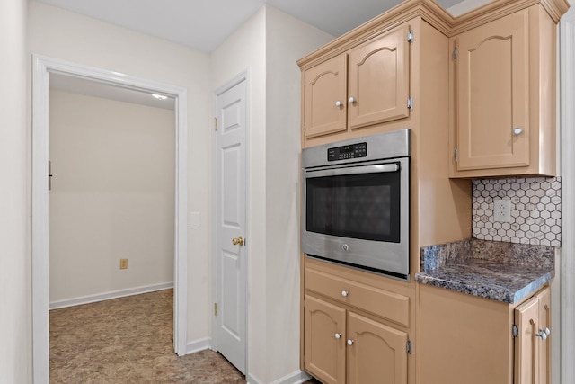 kitchen featuring stainless steel oven and light brown cabinets